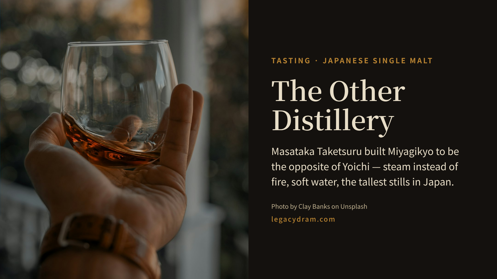 A hand holding a rounded glass of pale amber whisky up against a soft green-gold dusk, beside the article title and a line reading: one man built a second distillery to make the opposite of his first.